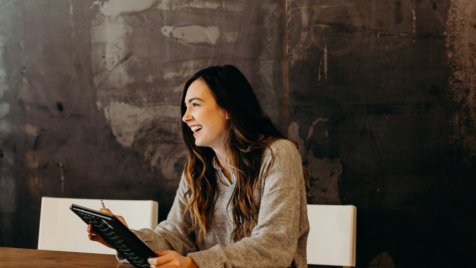 Small business owner reviewing a checklist on a tablet to assess AI readiness