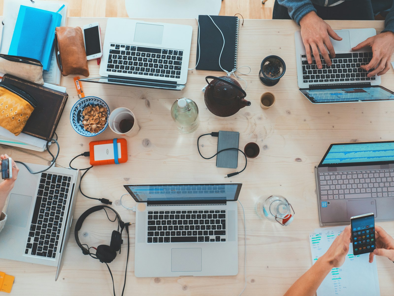 Small business team setting up AI tools together on their laptops